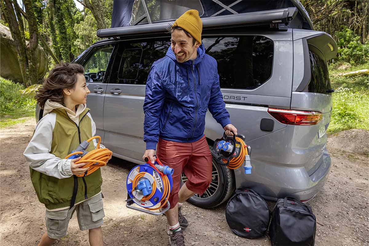 Mann mit Sohn geht von einem Camper weg